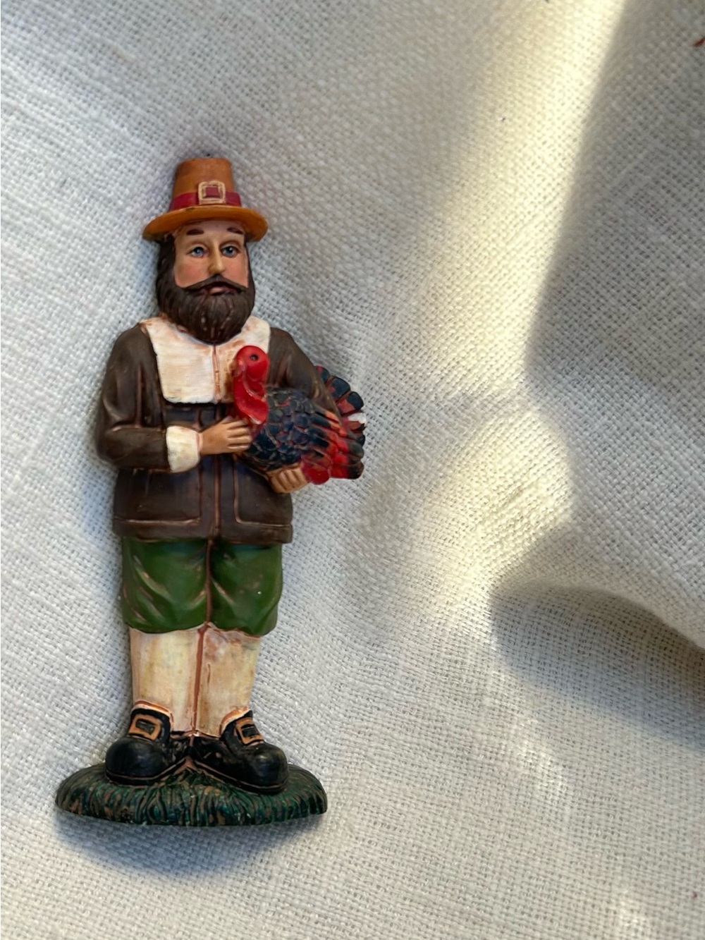 vintage hand-painted resin pilgrim man holding a turkey. Thanksgiving figurine.